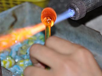 Glass Blowing Artist Forms Blob Glass Vessel Using Gas Torch Stock