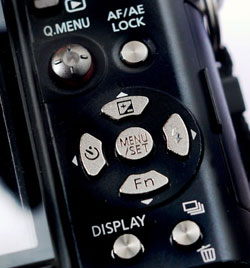 On many cameras, the exposure compensation button is on the toggle array.