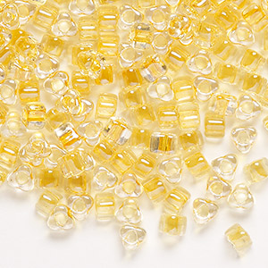 Seed bead, Miyuki, glass, transparent clear color-lined light gold, (TR1107), #5 triangle. Sold per 25-gram pkg.
