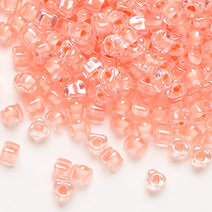 Seed bead, Miyuki, glass, transparent clear color-lined salmon, (TR1122), #5 triangle. Sold per 25-gram pkg.