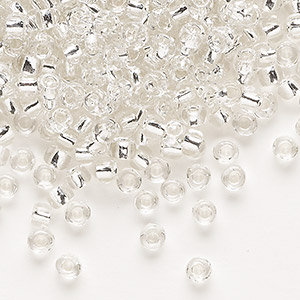Seed bead, Dyna-Mites&#153;, glass, silver-lined translucent clear, #6 round. Sold per 40-gram pkg.