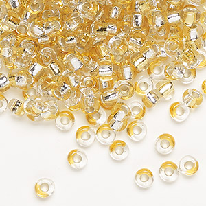 Seed bead, glass, silver-lined two-toned light gold/silver, 3-4mm uneven round. Sold per pkg of 25 grams.
