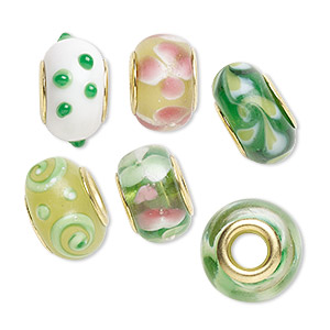 Bead, Dione&reg;, lampworked glass and gold-finished brass grommets, transparent green and opaque multicolored, 12x8mm-16x9mm rondelle with assorted designs. Sold per pkg of 6.