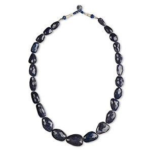 Bead, blue sapphire (dyed), dark, small to extra-large graduated hand-cut nugget, C grade, Mohs hardness 9. Sold per 21-inch strand.